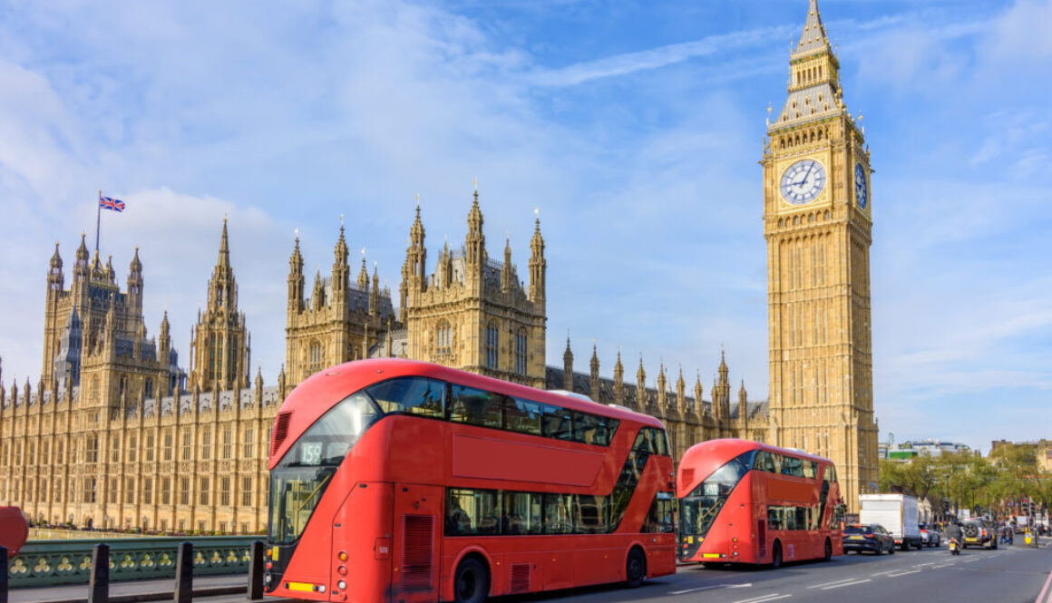 Houses of Parliament with Big Ben and double-decker buses on Westminster bridge, London, UK