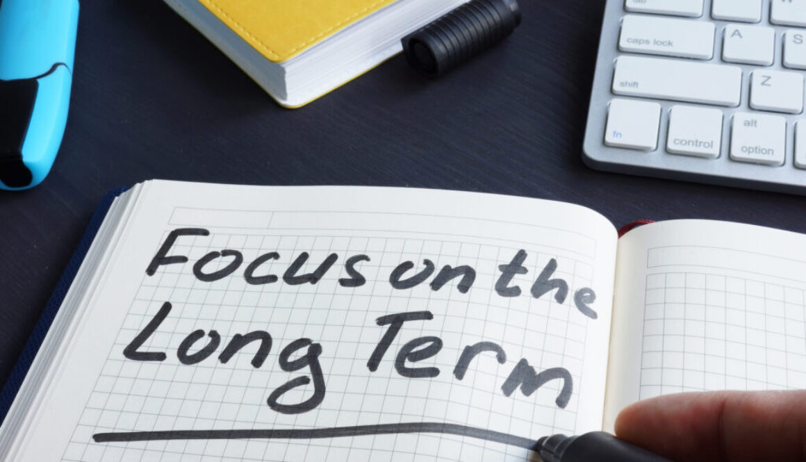 Man is writing focus on the long term.