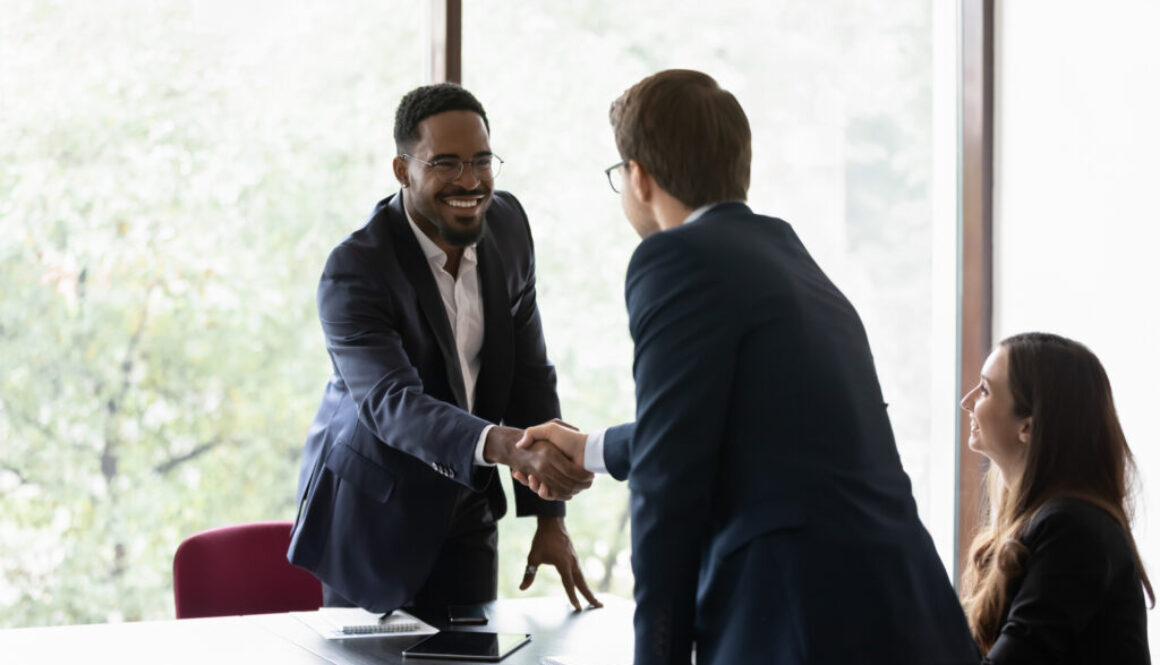 Multiethnic business partners start group meeting shake hands express regard