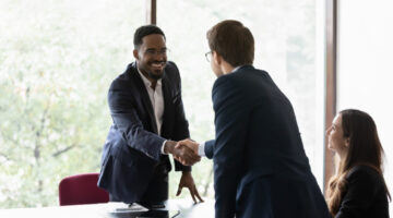 Multiethnic business partners start group meeting shake hands express regard