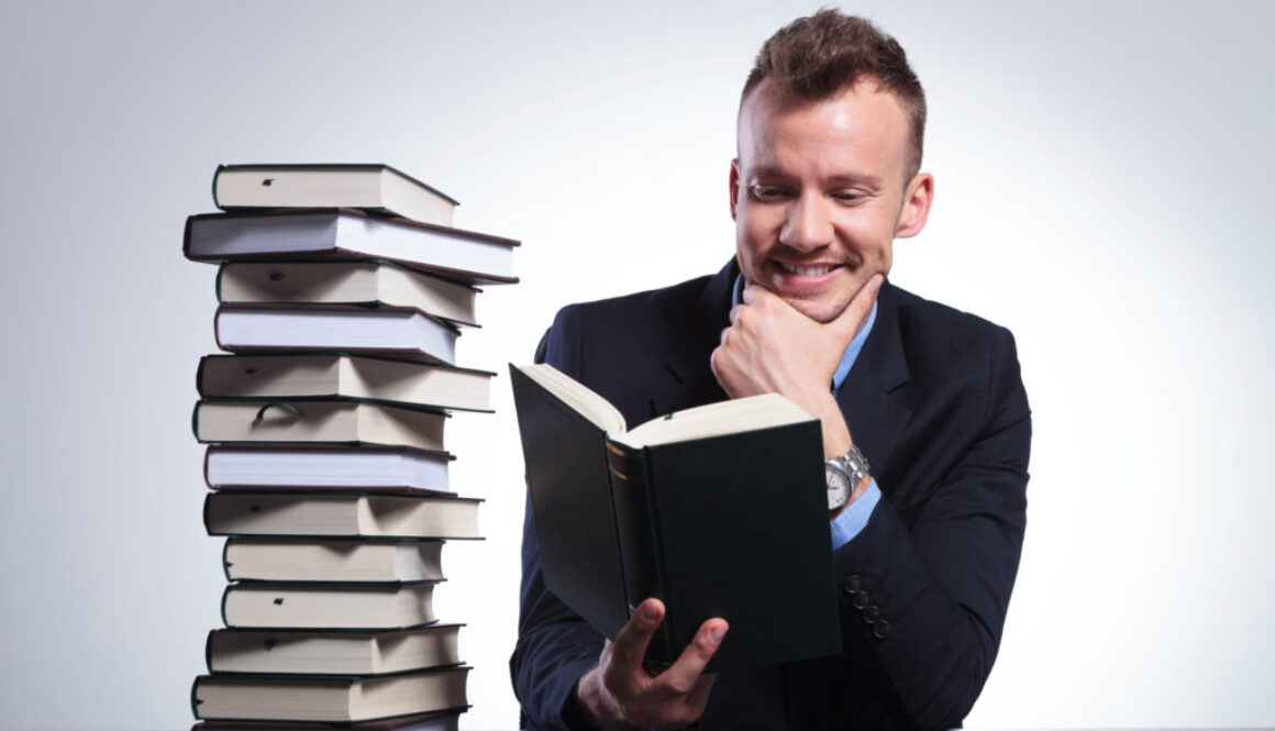 pensive business man smiles while reading