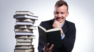 pensive business man smiles while reading