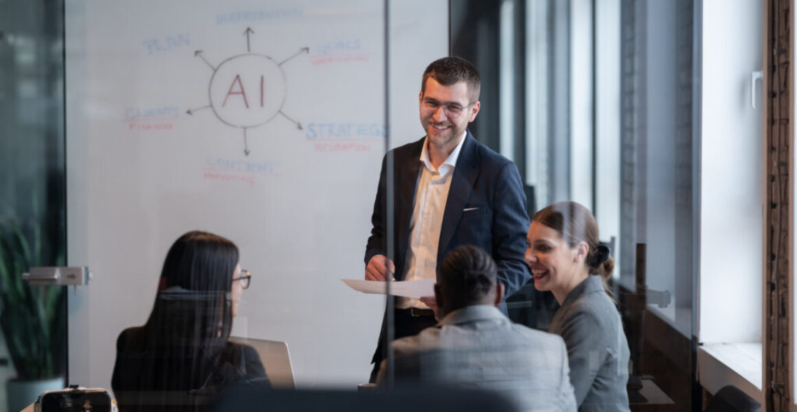Diverse business team in a modern office during a meeting, discussing artificial intelligence strategy. Concept of AI innovation, teamwork, leadership, corporate planning, professional collaboration Why Leaders Need Both Confidence and Humility