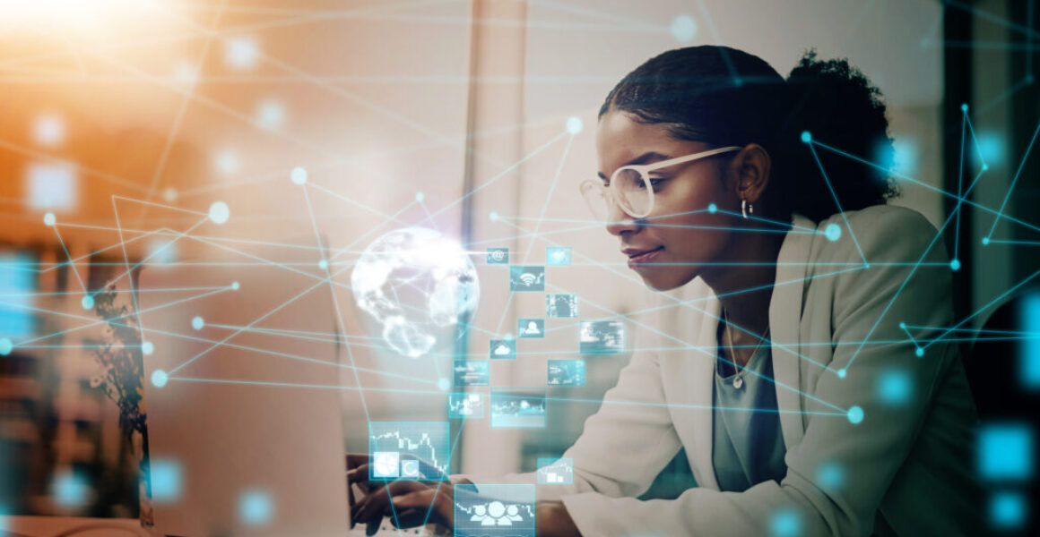 Business woman, AI and laptop with hologram, UX and networking for forex trading icon in office using virtual platform. Female using global technology for futuristic communication and innovation Leaders Debunk AI Myths: Elliott Broidy in Fast Company