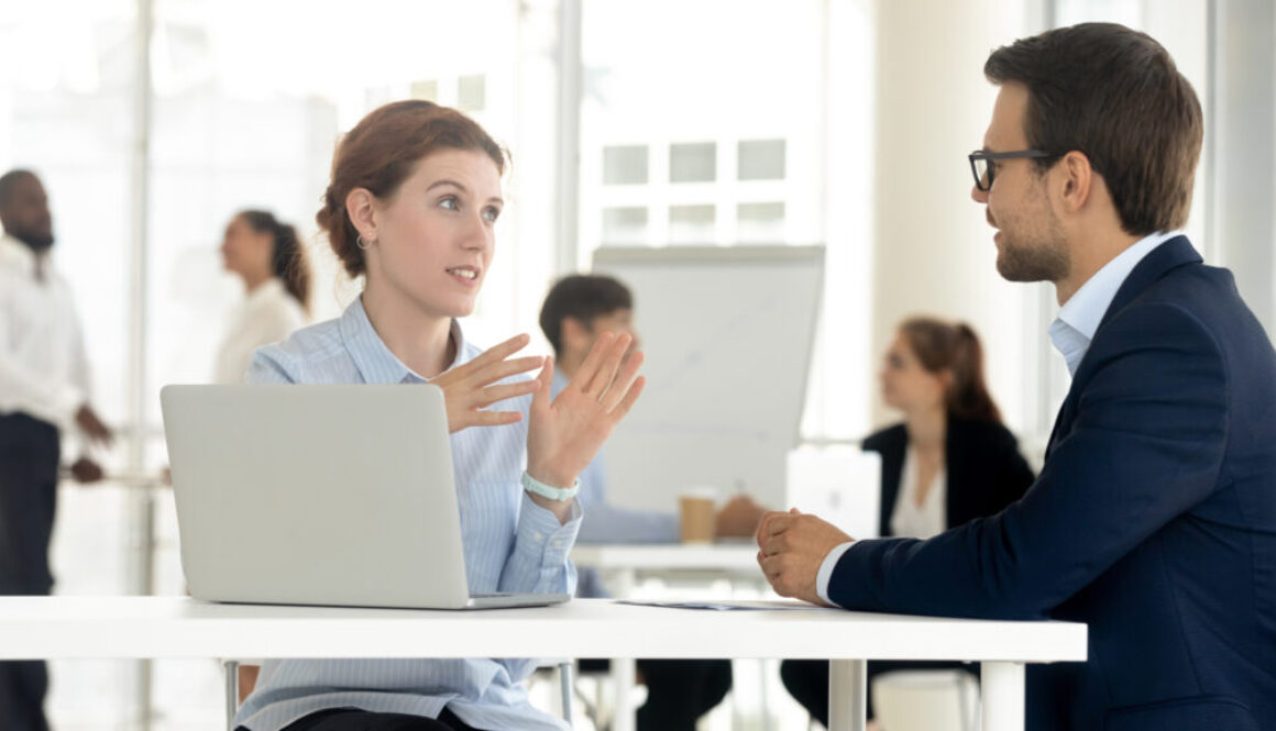 Diverse millennial employees talk discussing business ideas together