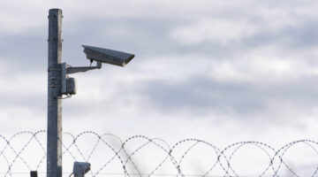 Surveillance Camera and barbed wire, border, prison, concept picture Washington Examiner Op-Ed Discusses LEO Technologies’ Verus Vision AI