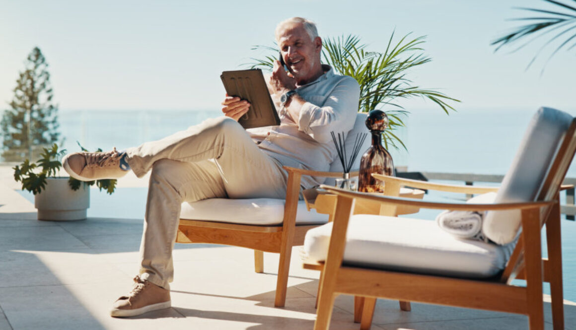 Phone call, tablet and relax with man at swimming pool for remote work, resort critic and customer feedback. Reading, freelancer and hospitality review with mature person at villa for luxury travel