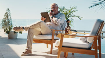 Phone call, tablet and relax with man at swimming pool for remote work, resort critic and customer feedback. Reading, freelancer and hospitality review with mature person at villa for luxury travel Leaders on How They Actually Disconnect on Vacation: Elliott Broidy in Fast Company