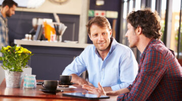 Two men meeting at a coffee shop Elliott Broidy on Professional Community in Fast Company